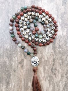 A mala is a Buddhist prayer rosary consisting of 108 beads + 109 Guru Bead. Each bead is threaded on a silk cord and separated by a knot tied during meditation and chanting (mantra recitation).  This handcrafted mala by me is made of Jasper, Dalmatian Jasper, and Indian Agate stones.  The mala is completed with a Guru Bead in the form of Dalmatian Jasper. The bead diameter is 6mm. Adjustable Agate Hand-strung Mala, Adjustable Hand-strung Agate Mala, Bohemian Agate Mala With Gemstone Beads, Agate Gemstone Beads Mala For Meditation, Spiritual Agate Mala With Round Beads, Bohemian Agate Mala With Round Beads, Adjustable Agate Mala With Round Beads, Bohemian Hand-strung Healing Rosary, Bohemian Hand-strung Rosary For Healing