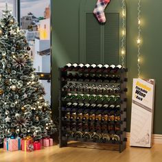 a christmas tree is next to a wine rack