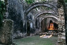 an old stone building with candles lit inside