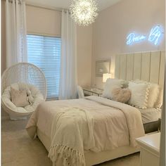 a bed room with a neatly made bed and a hanging chair