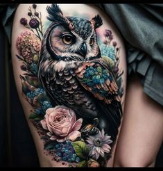 an owl and flowers tattoo on the thigh