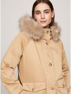 Tommy Hilfiger women's coat. Look forward to chilly-day style with this padded parka, featuring a non-detachable hood with removable faux-fur trim for a plush finish.  Material: 100% Recycled Polyester. Tommy Hilfiger Coat Women, Hooded Parka With Faux Fur Trim, Solid Color Hooded Parka With Faux Fur Trim, Beige Parka With Adjustable Hood For Cold Weather, Beige Parka With Double-lined Hood For Cold Weather, Beige Hooded Fur Coat With Faux Fur Trim, Tommy Hilfiger Winter Outerwear, Tommy Hilfiger Coat, Hooded Parka