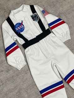 a white space suit with nasa patches on the chest and red, white, and blue stripes