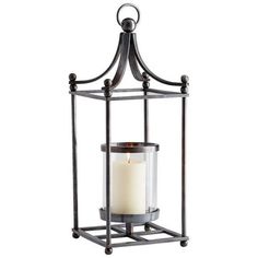 a candle that is inside of a metal cage with a glass holder on the top