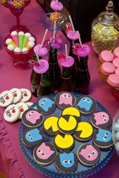 a table topped with lots of cupcakes and cookies