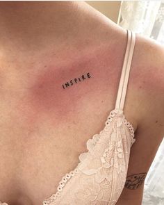 a woman's chest with the word inspire tattooed on her left shoulder and right breast