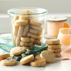 a glass jar filled with cookies on top of a table