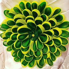 a large green and yellow flower on a white cloth