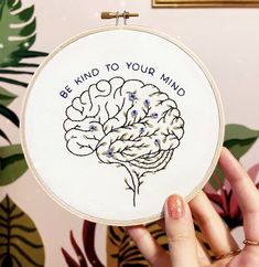 someone is holding up a cross - stitch project with the words, be kind to your mind