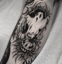 a black and white photo of a horse with flowers on it's leg, next to a skull