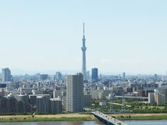 an aerial view of a city with tall buildings and a bridge in the foreground