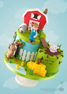 a cake decorated with farm animals and a farmer on top