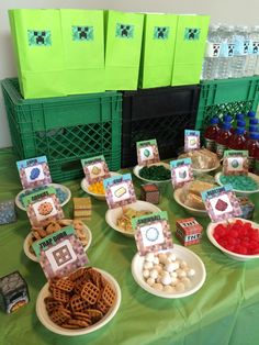 a table topped with plates filled with different types of snacks and drinks on top of it