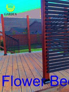 a wooden deck with black slats and blue text that says flower bed on it