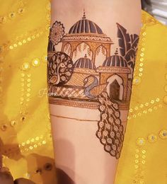 a close up of a person's arm with a henna tattoo on it