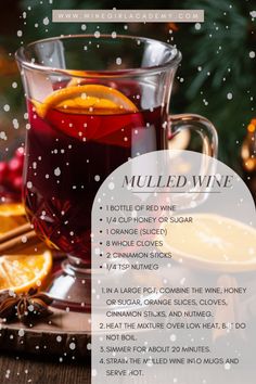 a cup of mulled wine next to an orange slice