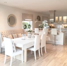 a white table and some chairs in a room