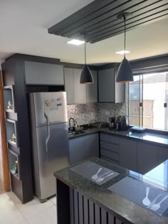 a modern kitchen with stainless steel appliances and granite counter tops