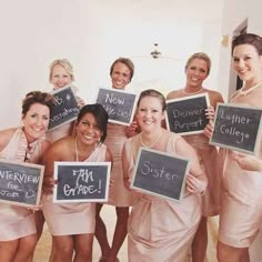 a group of women holding up signs in front of them