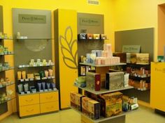 a store with yellow walls and shelves filled with products for sale in it's display area