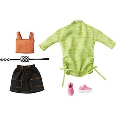 the doll is wearing a green shirt and black skirt with pink shoes on top of it