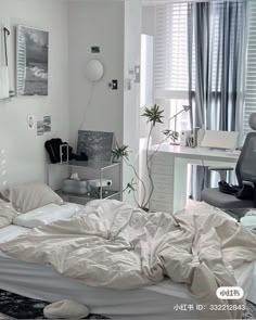 an unmade bed sitting in a bedroom next to a desk