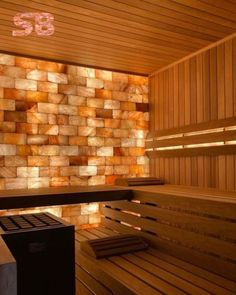 the inside of a sauna with wooden benches and lights on it's sides