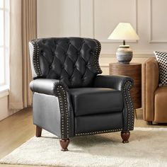 a black leather recliner with studded trimmings in a living room setting