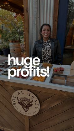 a woman standing in front of a food stand with the words huge profits on it