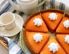 there is a pie on the table with white cups and saucers next to it