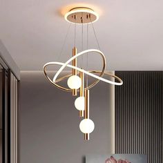 a modern chandelier hanging from the ceiling in a living room or dining room