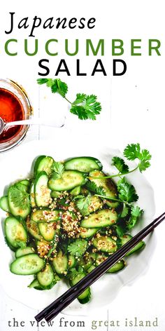 japanese cucumber salad on a white plate with chopsticks and sauce in the background