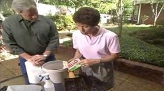 an older couple is making something out of a trash can and another person is looking at it