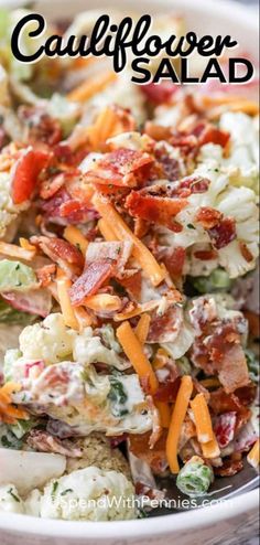 a salad with bacon, cheese and lettuce in a white bowl on a wooden table