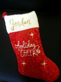 a red and white christmas stocking with the words jordan holiday cheer written on it