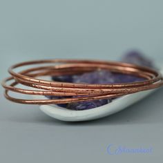 "This set of 4 handmade copper bangle bracelets absolutely sing while you are wearing them! Made from 12 gauge copper wire that has been soldered, then textured, they are light and comfortable, and can be custom made to order in whatever size you would prefer. They can also be sealed, to help keep the copper from reacting with your skin and to help keep the copper bright and shiny, or antiqued to give the copper a darker finish. Just let me know your preference on checkout. Bangle Sizes: (Rememb Handmade Copper Bangle, Copper Bangle Gift, Bohemian Rose Gold Bangle For Gift, Rose Gold Bohemian Bangle As Gift, Bohemian Rose Gold Bangle Gift, Handmade Bangle Bracelets, Bangle Bracelet Set, Handmade Bangles, Stacked Bangles