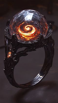 a ring with a spiral design on it sitting on top of a table next to a candle