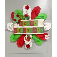 a christmas wreath made out of flip flops and other holiday decorations on a door