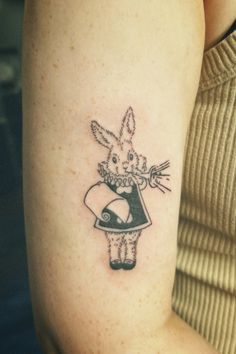 a small rabbit tattoo on the arm