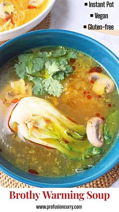 broth soup in a blue bowl with mushrooms, celery and parsley