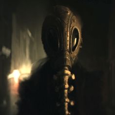 a man wearing a gas mask in the dark