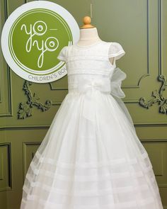 A cute yet traditional first communion gown for girls made with lightweight natural organza, it has details with embroidered polka dots, laces, pleats, and punto Paris. The dress has buttons on the back and a bow for closure. The bow on the front is an applique that can be removed. Dry clean Does not include crinoline Made in Spain Final sale, no exchanges nor returns are available Fitted Dress With Bow For Confirmation, Organza Lace Trim Dress For Confirmation, Organza Baptism Dress With Lace Bodice For Confirmation, First Communion Dress With Ruffles And Fitted Bodice, Classic Lace Bodice Dress For First Communion, Organza Confirmation Dress With Lace Trim, Fitted Dresses With Satin Bow For First Communion, Fitted Tulle First Communion Dress For Confirmation, White Pleated Bodice Dress For First Communion