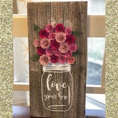 a painted mason jar with roses on it