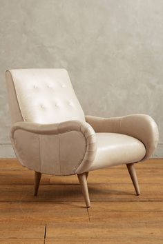 a white chair sitting on top of a wooden floor