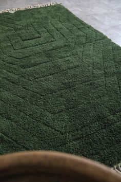 a green area rug on the floor