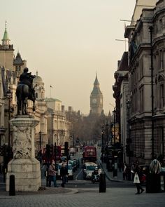 a city street with cars and people walking on it