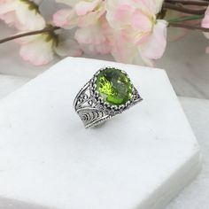 925 Sterling Silver Oval Filigree Ring with Peridot Doublet Quartz Natural Gemstone  Material: 925 Solid Sterling Silver, Peridot Gemstone Gemstone Dimensions: 12 mm x 10 mm, Oval, Faceted Ring Face Length: 0.60 inch   Ring Face width: 0.50 inch This will come in a designer pouch & gift box  Free Domestic Shipping  It is a gift that will create memories for years to come. Our fine silver jewelry is Made in our exclusive Artisan workshops in Turkey. Our aim is to exceed all the expectations that Green Oval Filigree Ring In Sterling Silver, Handmade Oval Peridot Rings, Green Oval Engraved Rings, Green Filigree Ring As Fine Jewelry Gift, Green Filigree Ring Fine Jewelry For Gift, Silver Leaf Art, Faceted Ring, Fine Silver Jewelry, Oval Ring