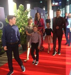 a group of people that are standing on a red carpet