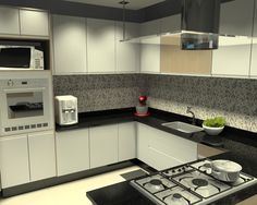 a modern kitchen with white cabinets and black counter tops, including a stove top oven