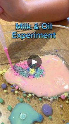 a child is making a pink and blue cake with sprinkles